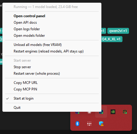 The Windows notification-area menu for StudioForge: a header line reading Running — 1 model loaded, 23.4 GiB free, then Open control panel, Open API docs, Open logs folder, Open models folder, Unload all models (free VRAM), Restart engines, Start server greyed out, Stop server, Restart server, Copy MCP URL, Copy MCP PIN, a ticked Start at login, and Quit