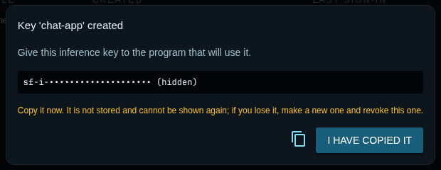 A dialog titled Key chat-app created, with the token hidden, the warning that it is not stored and cannot be shown again, a copy button and an I have copied it button.